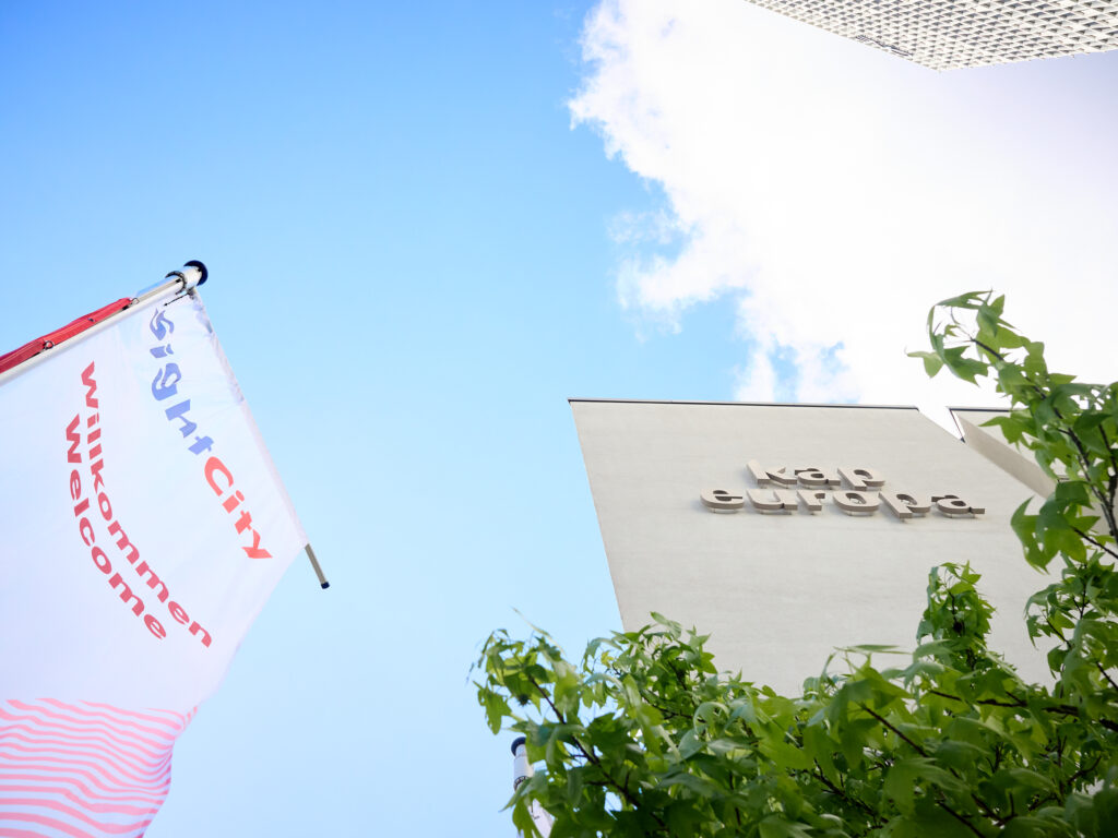 View of the sky with the "Kap Europa" lettering and a SightCity flag in front of it