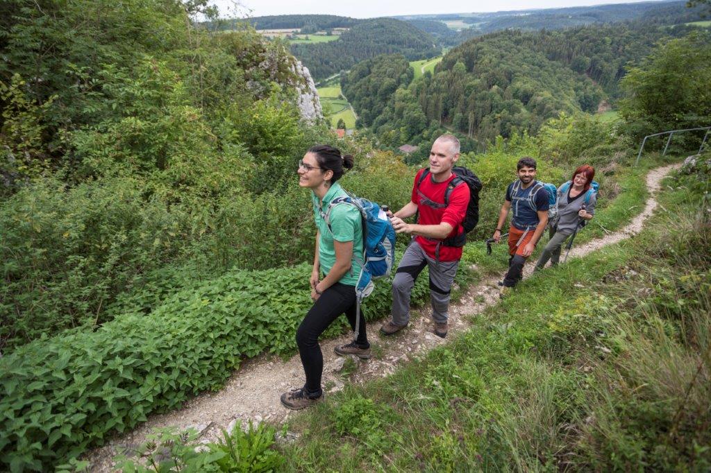 tour de sens group on a trekking trail, Sighted guests accompany their blind travel mates.