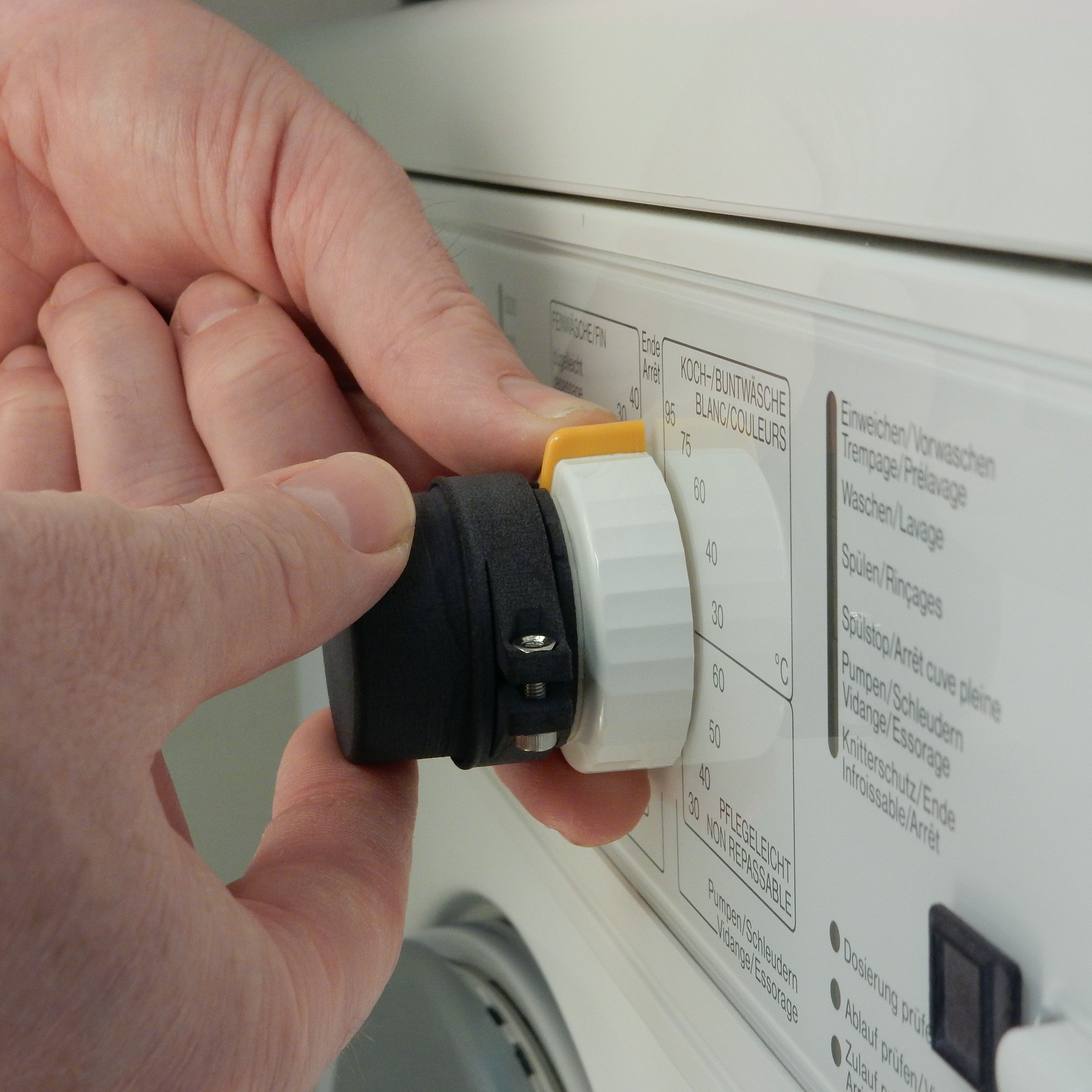 The Feelware Audio control knob is mounted on the program selector switch of the tumble dryer.