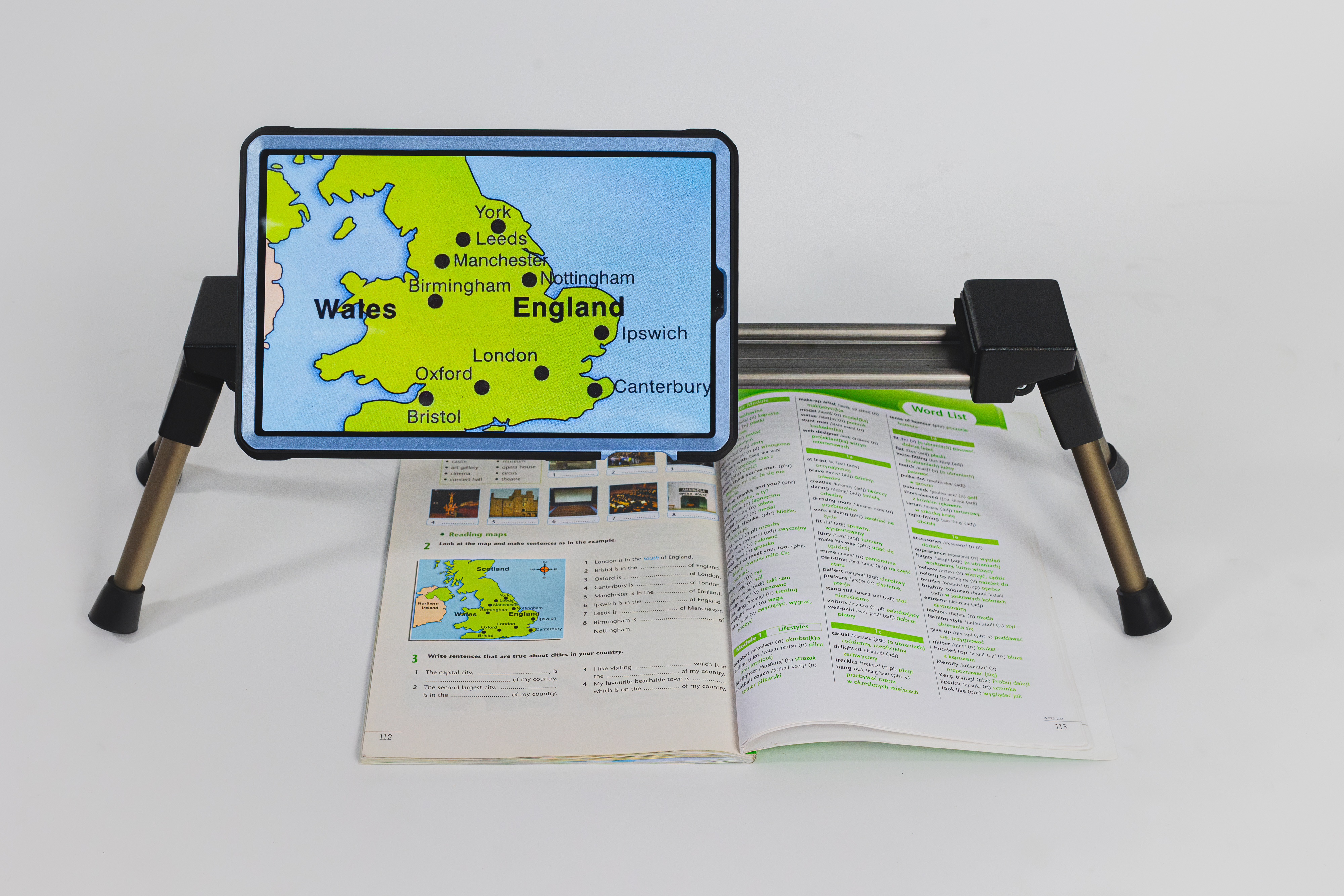 Spider Magnifier, the screen displays magnified text from the newspaper beneath it.